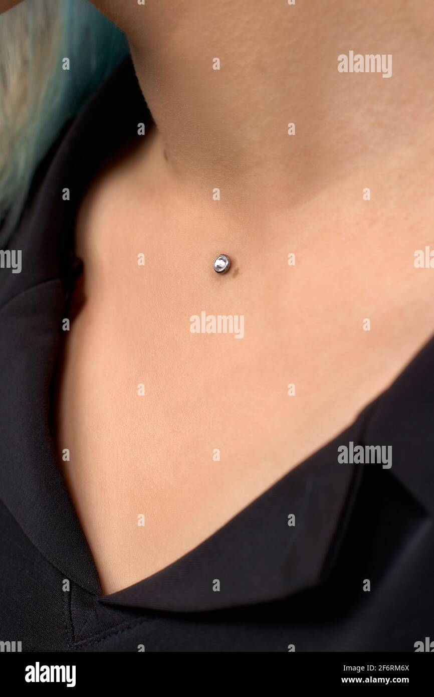 Beautiful piercing on the neck of a woman close-up. A modern way of piercing  Stock Photo - Alamy