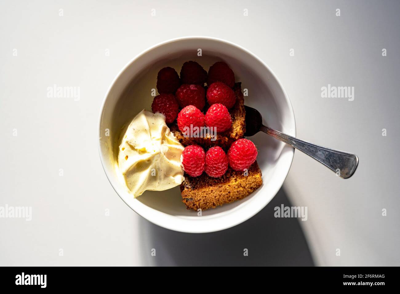 Homemade ginger cake with ice cream and raspberries Stock Photo