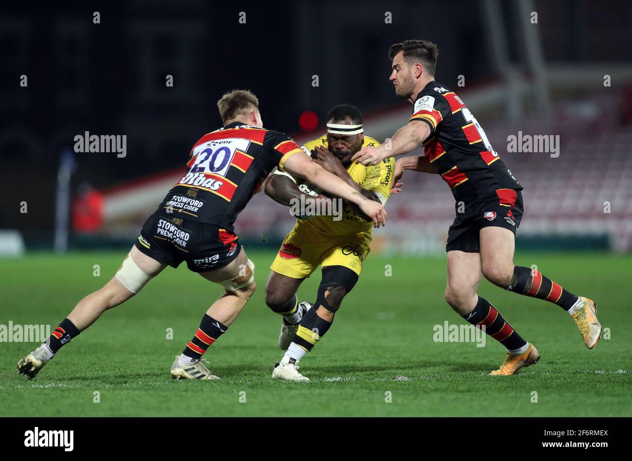 La Rochelle's Levani Botia is tackled by Gloucester Rugby's Freddie Clarke and Mark Atkinson during the Heineken Champions Cup match at Kingsholm Stadium, Gloucester. Picture date: Friday April 2, 2021. Stock Photo
