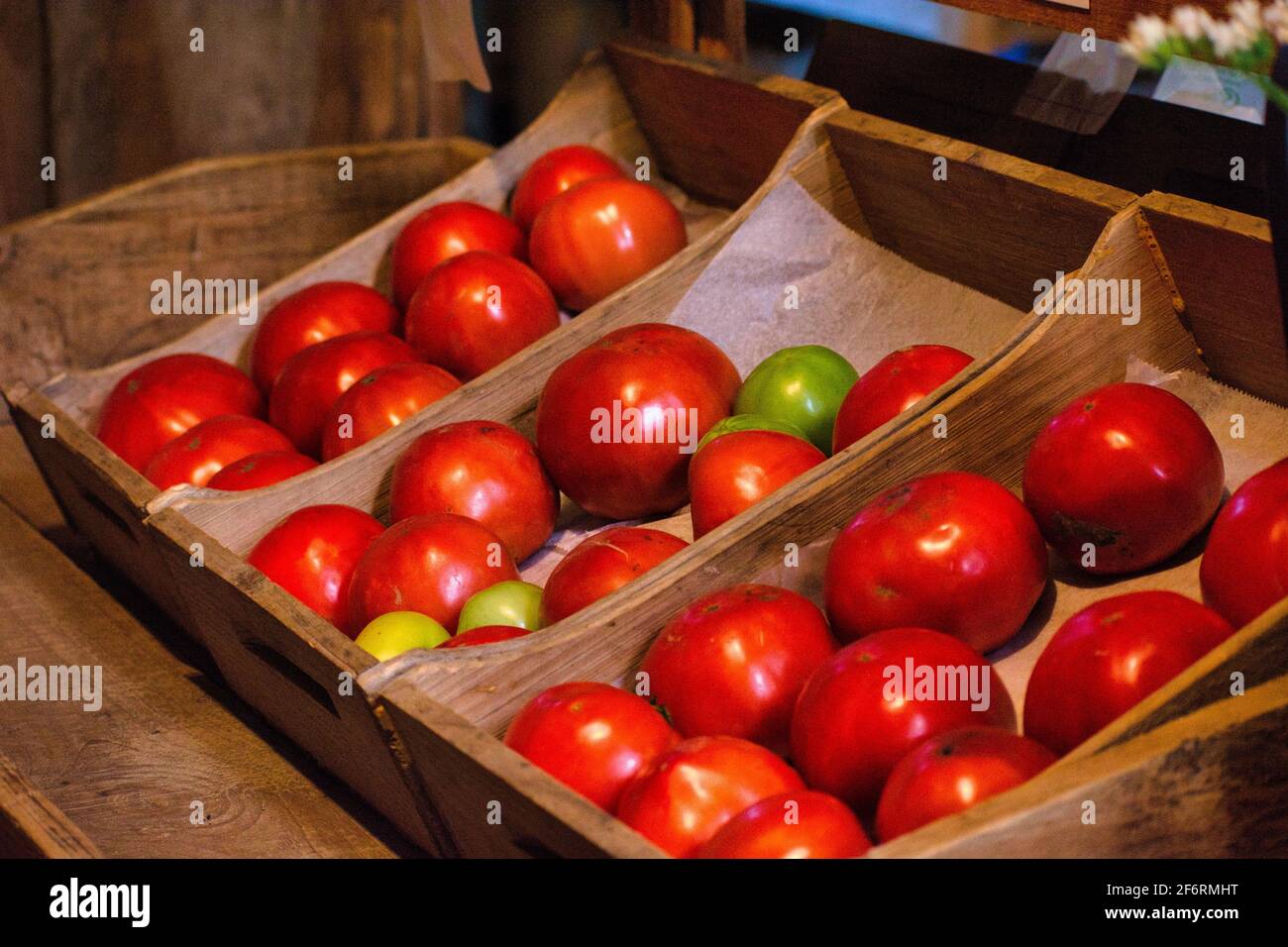 Fresh garden tomatoes in wood crates for sale at a farmer's market Stock Photo