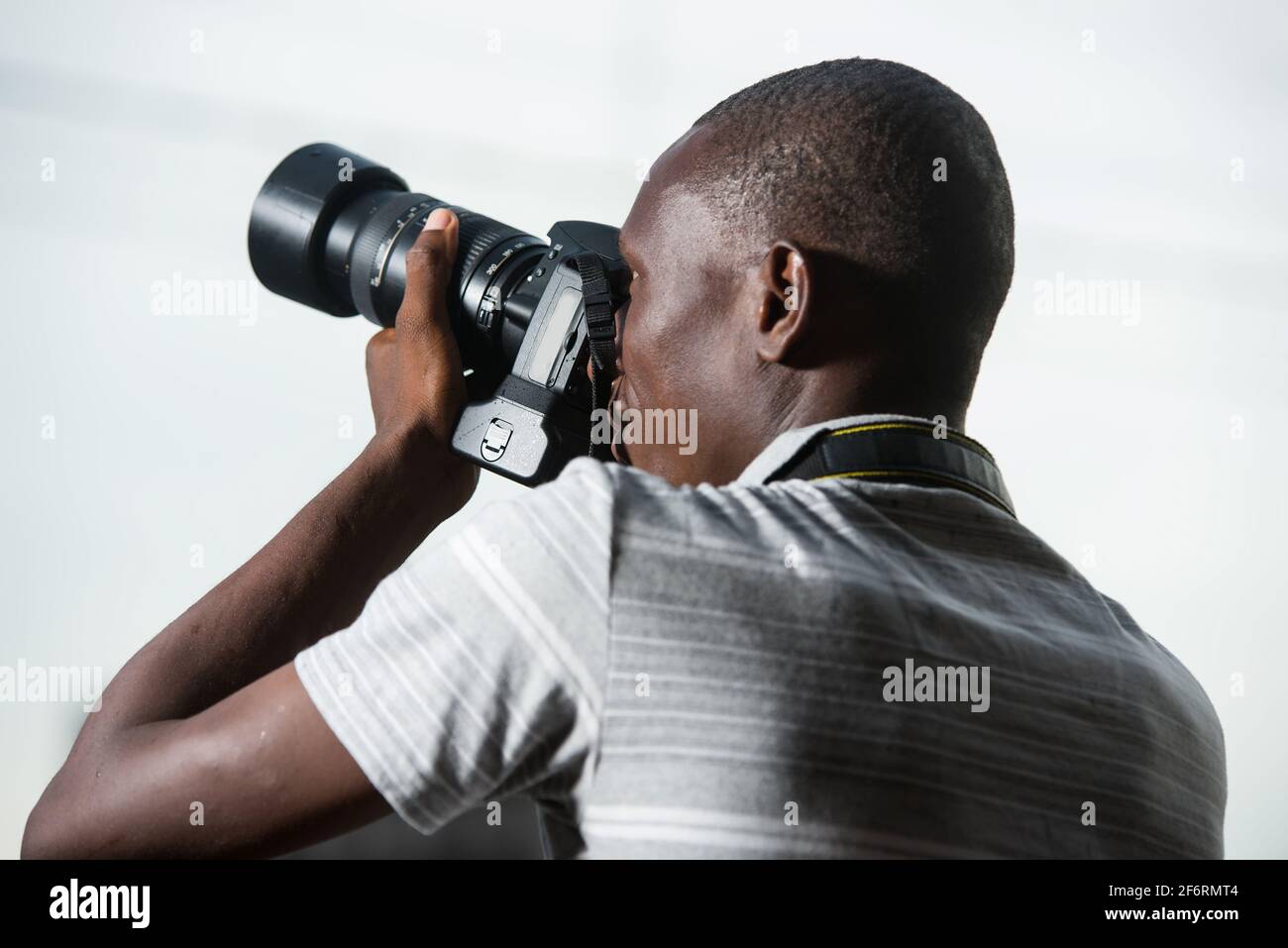 young man outdoors photographing something. Stock Photo
