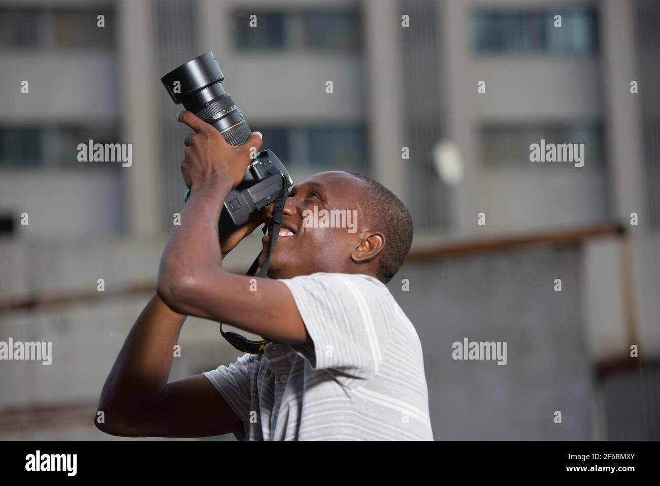 young man outdoors photographing something. Stock Photo