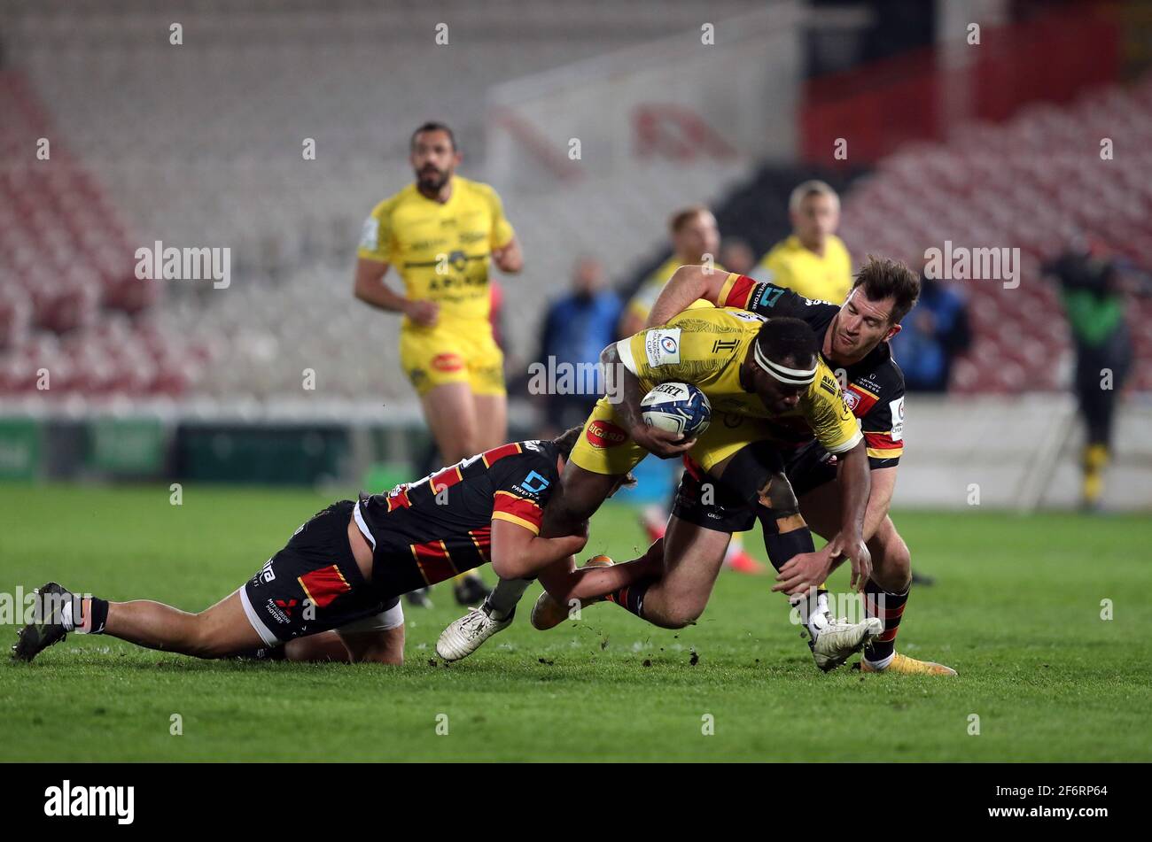 La Rochelle's Levani Botia is tackled by Gloucester Rugby's Santi Socino and Mark Atkinson during the Heineken Champions Cup match at Kingsholm Stadium, Gloucester. Picture date: Friday April 2, 2021. Stock Photo