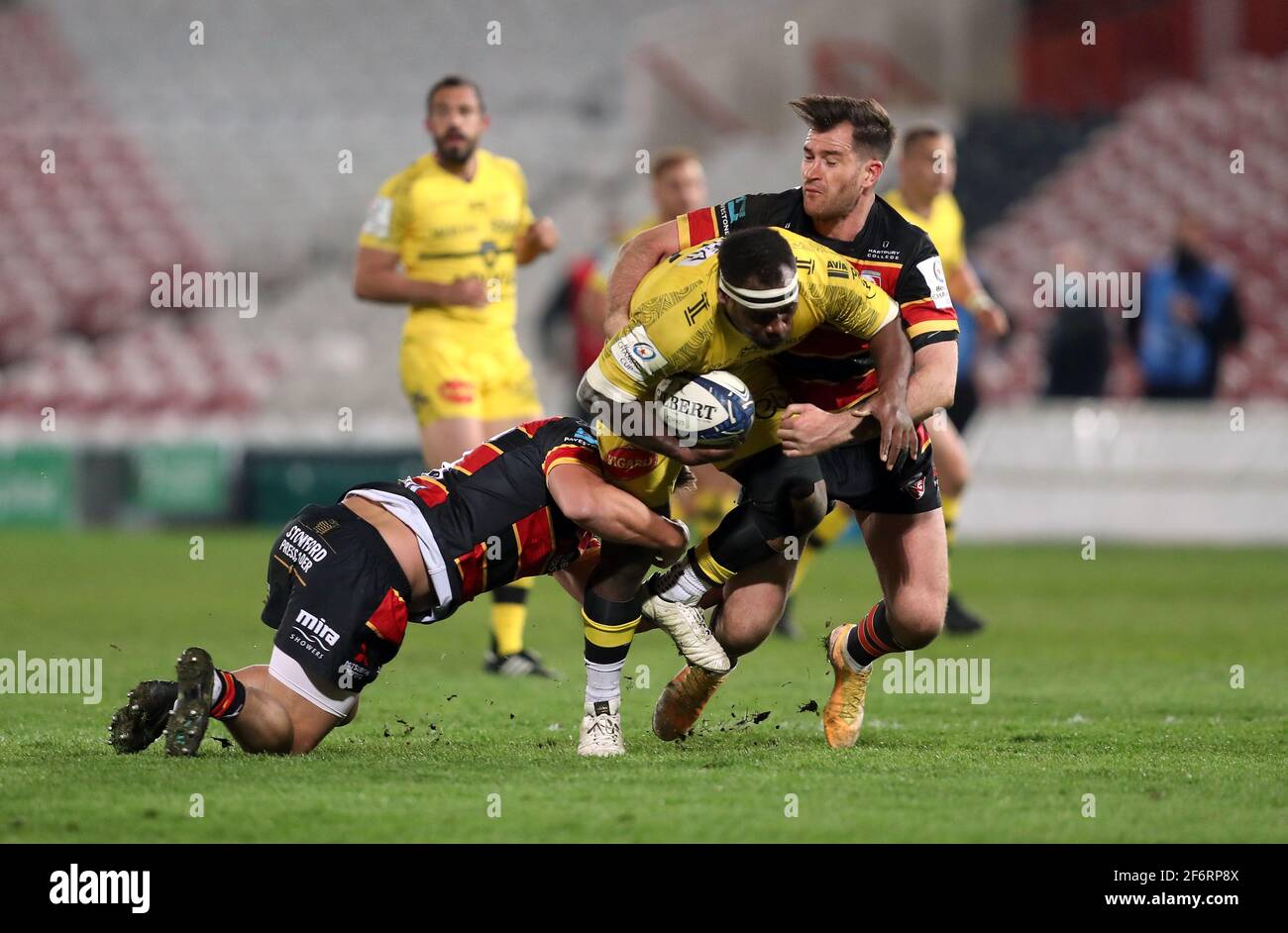 La Rochelle's Levani Botia is tackled by Gloucester Rugby's Santi Socino and Mark Atkinson during the Heineken Champions Cup match at Kingsholm Stadium, Gloucester. Picture date: Friday April 2, 2021. Stock Photo