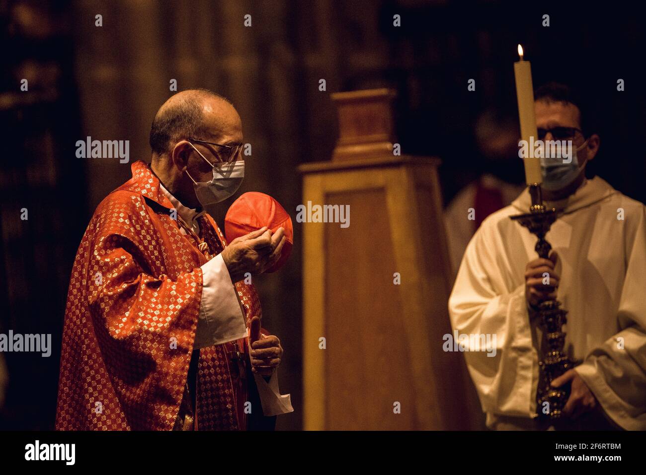 Barcelona, Spain. 2nd Apr, 2021. Cardinal Archbishop of Barcelona, JOAN JOSEP OMELLA, takes off his zucchetto as he celebrates the Holy Friday Mass with a greatly reduced church congregation under strict hygiene measure due to the continuous spread of the COVID-19 virus. Credit: Matthias Oesterle/Alamy Live News Stock Photo