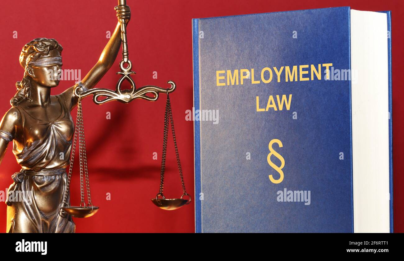 Symbol image: Reference book employment law and a Justitia. Stock Photo