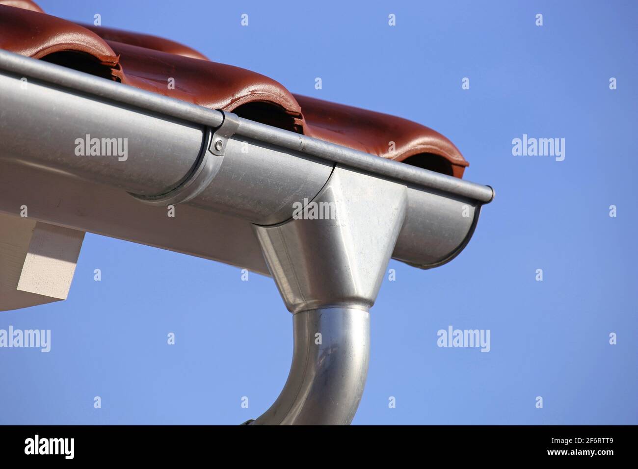 Roof gutter on a new tiled roof Stock Photo Alamy