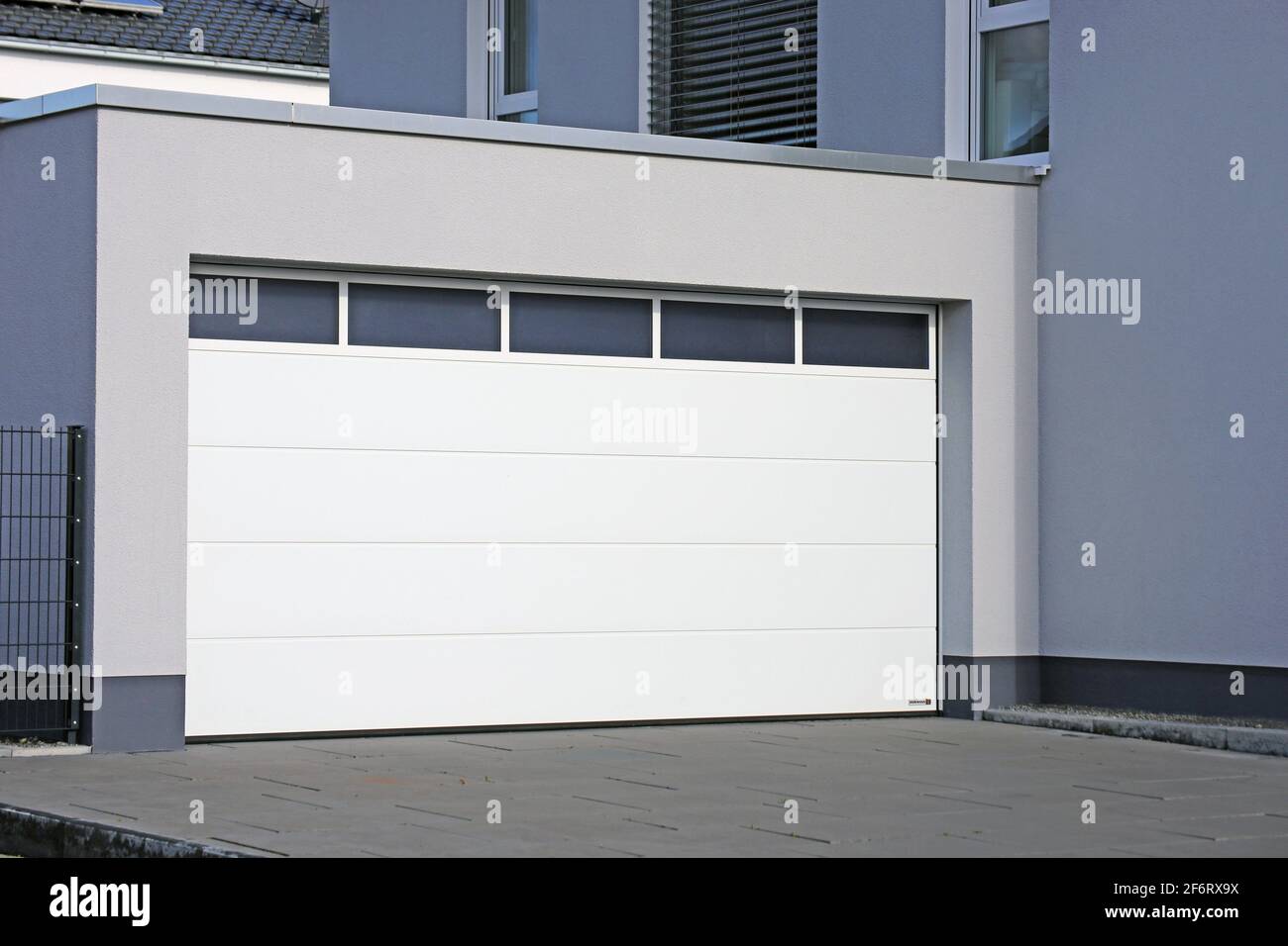 Modern white garage door (sectional door). Stock Photo