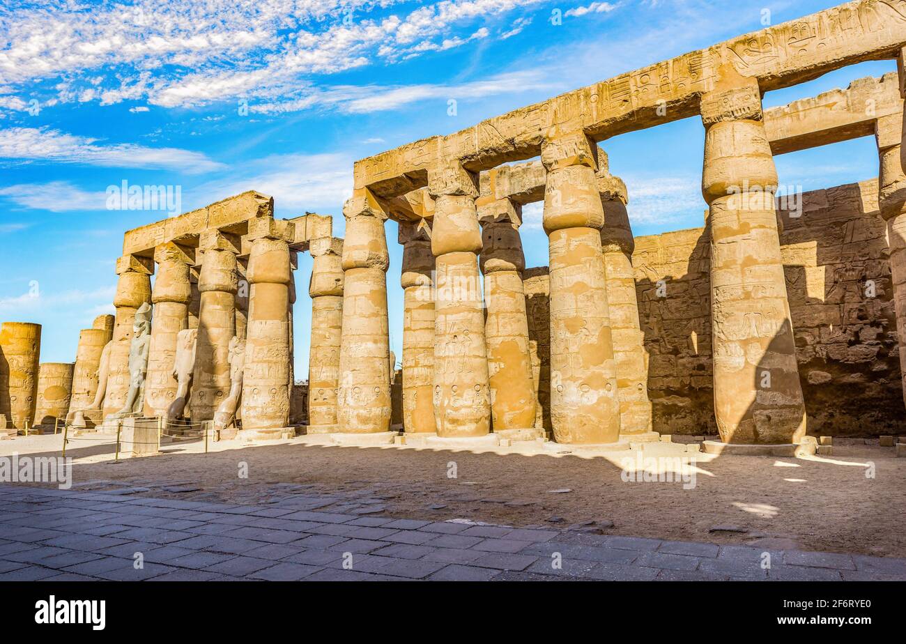 Colonnade in Karnak Temple and blue cloudy sky, Luxor. Stock Photo