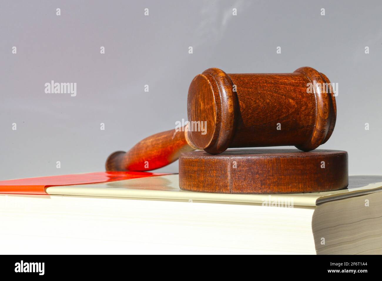 Book and judge's gavel as a symbol image for a court verdict. Stock Photo