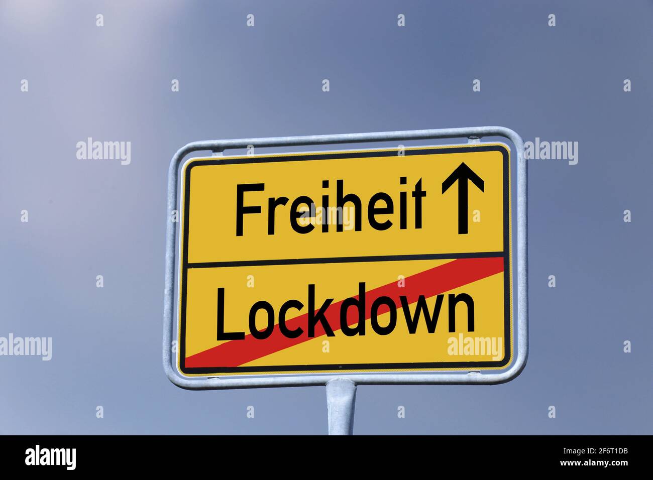 Symbol image: German town-sign with the letters Freiheit / Lockdown (Freedom / Lockdown). Stock Photo