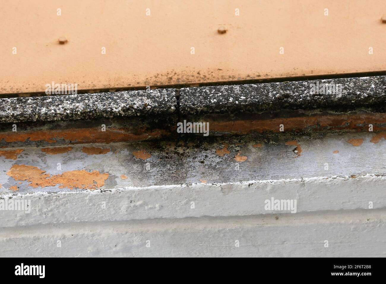 Concrete damage due to moisture and wetness on a balcony in need of renovation. Stock Photo