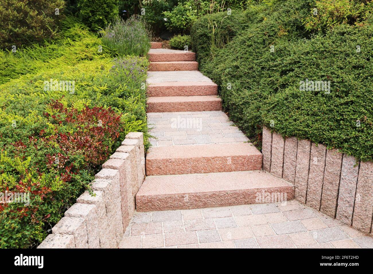 Neat and tidy front yard with solid block steps, decorative gravel and planting. Stock Photo