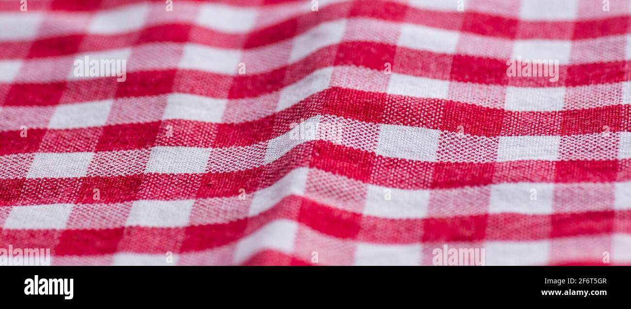 Red and white kitchen cotton fabric in a cage. fabric cotton texture