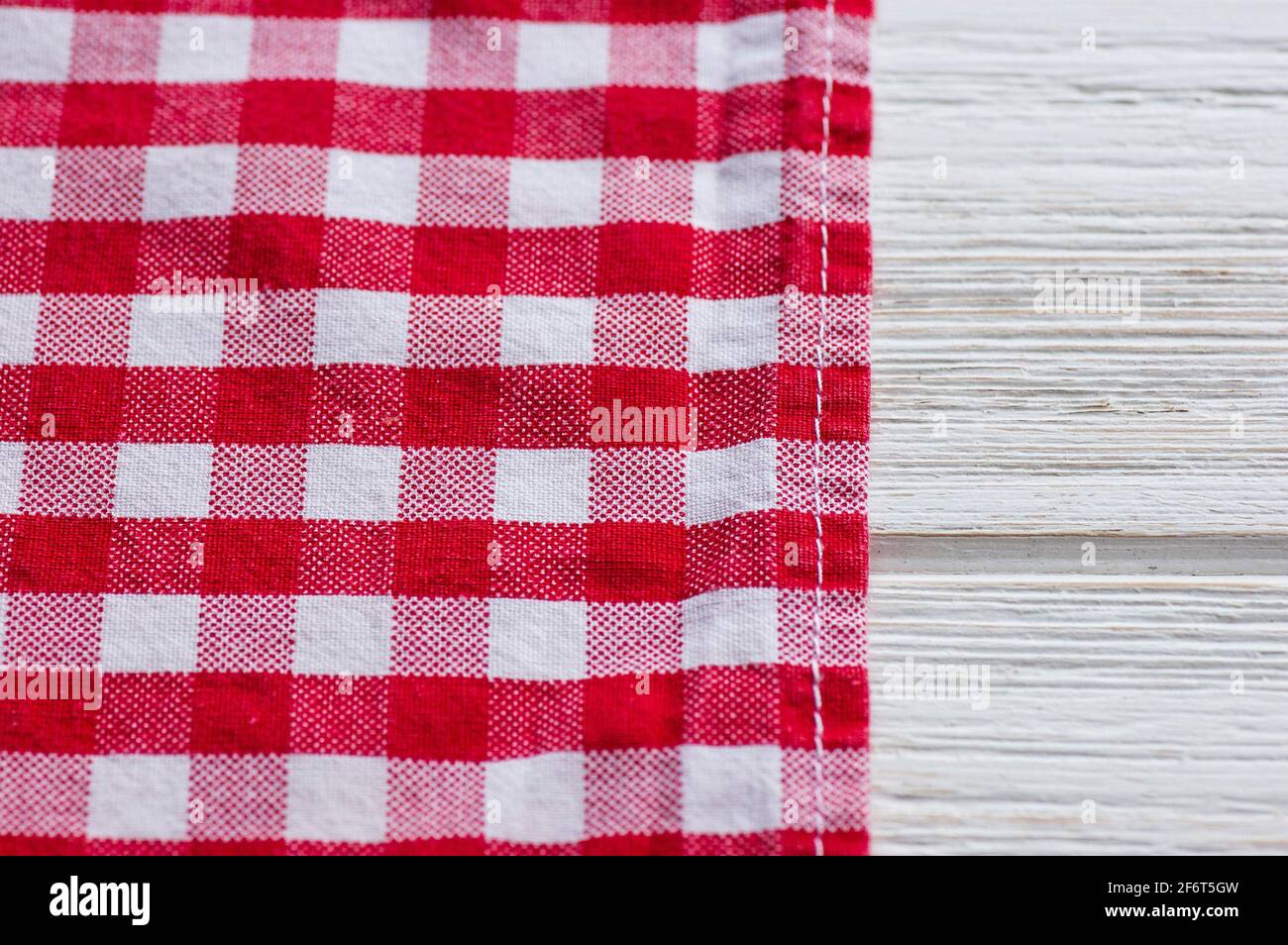 Red and white kitchen cotton fabric in a cage. fabric cotton texture