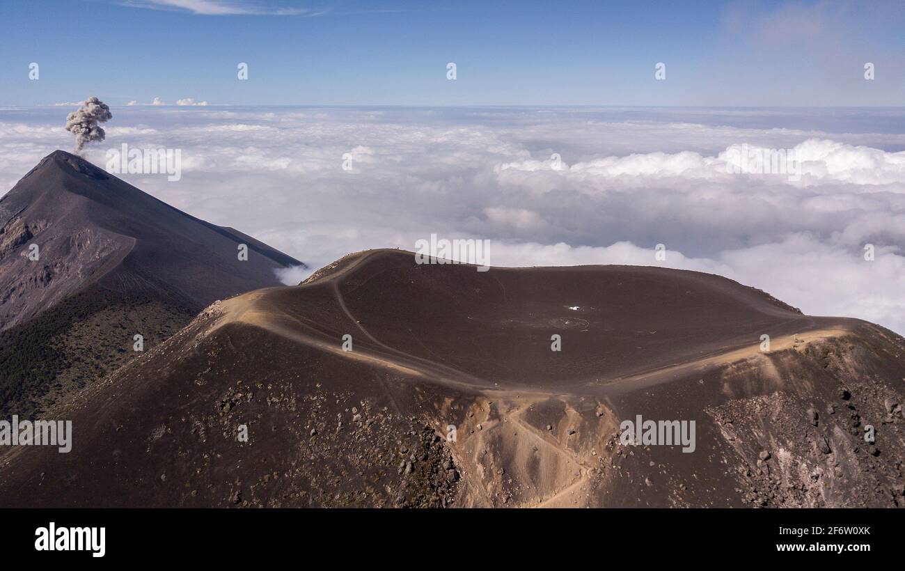 Acatenango, Guatemala. 17th Mar, 2021. In this aerial view, the crater of Acatenango Volcano is seen in front of an erupting Fuego Volcano in Acatenango, Guatemala on March 17, 2021. Credit: Josh Edelson/ZUMA Wire/Alamy Live News Stock Photo