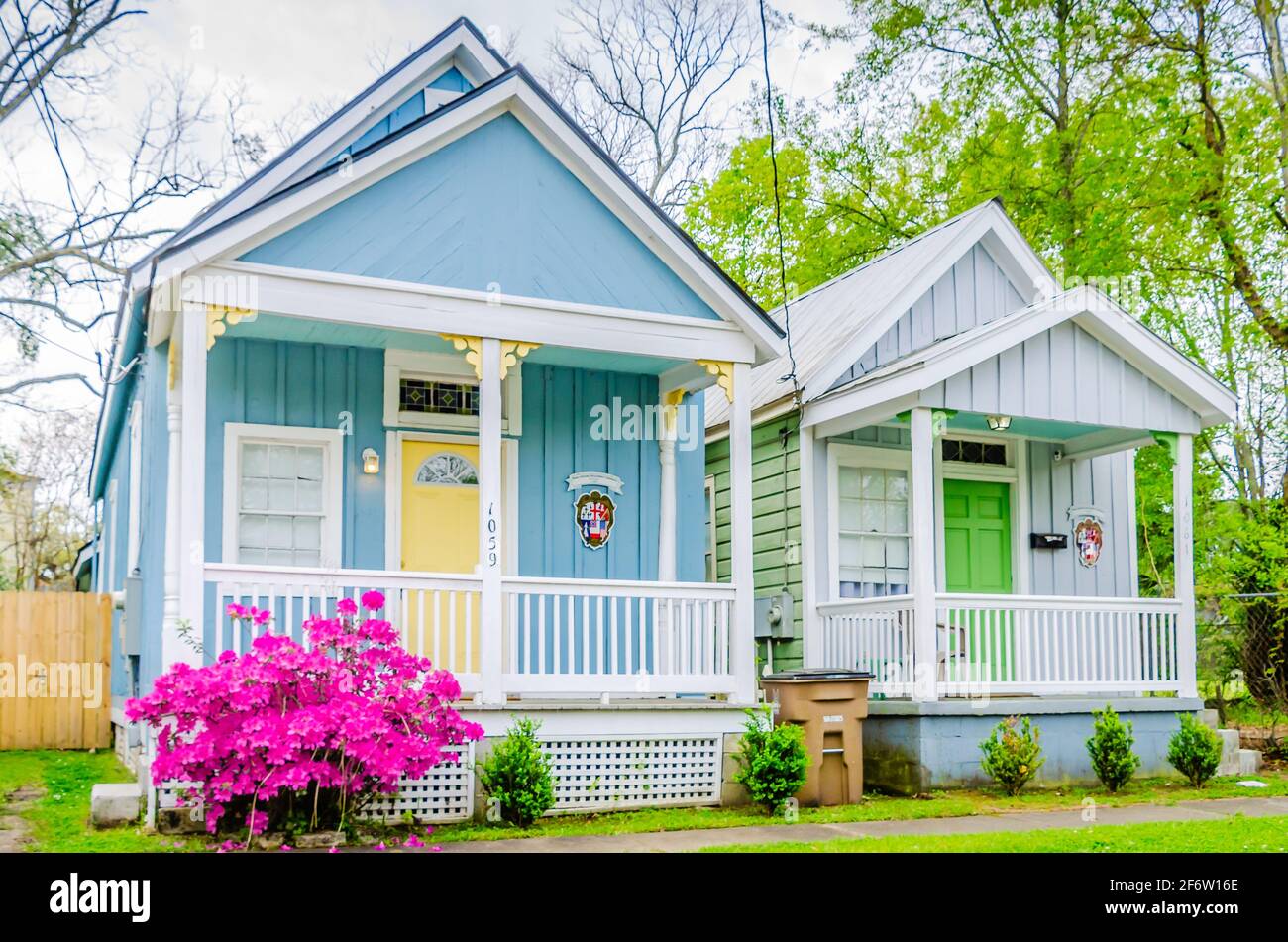 Century-old shotgun houses are repurposed as Airbnb vacation rentals on Caroline Avenue in the Old Dauphin Way Historic District in Mobile, Alabama. Stock Photo