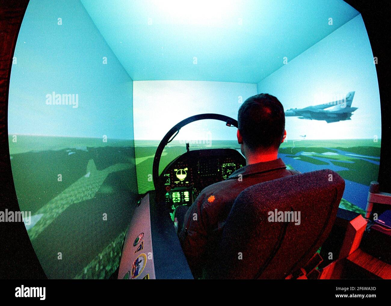 ABOARD USS INDEPENDENCE (Mar. 10, 1998) -- Lt. Cdr. Bryan Kust from Pennington, NJ sits in a F/A-18 Hornet flight simulator aboard the aircraft Stock Photo