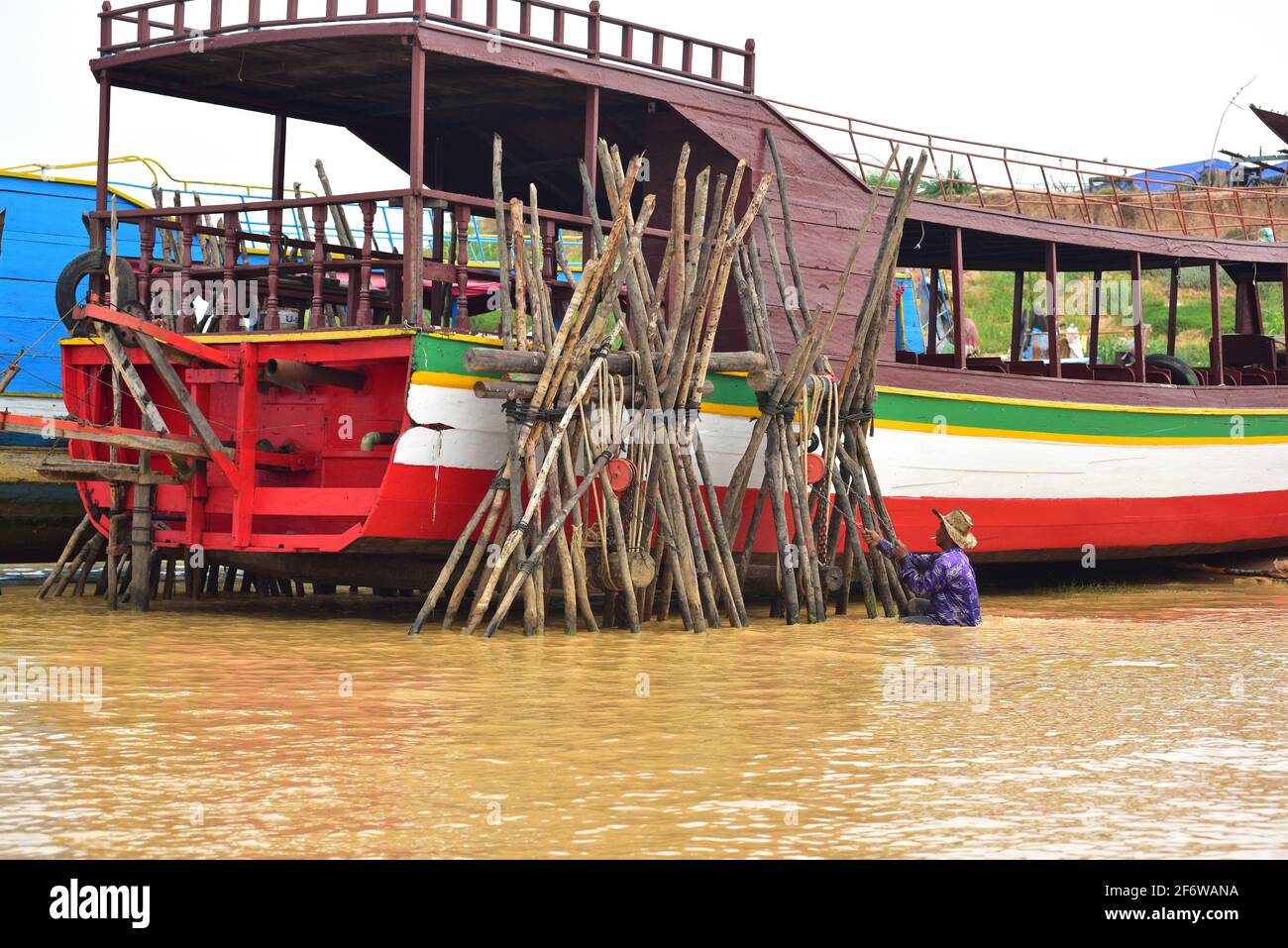 Moored boat on a river bank. Tonle Seap river, Siem Reap, Cambodia. Stock Photo