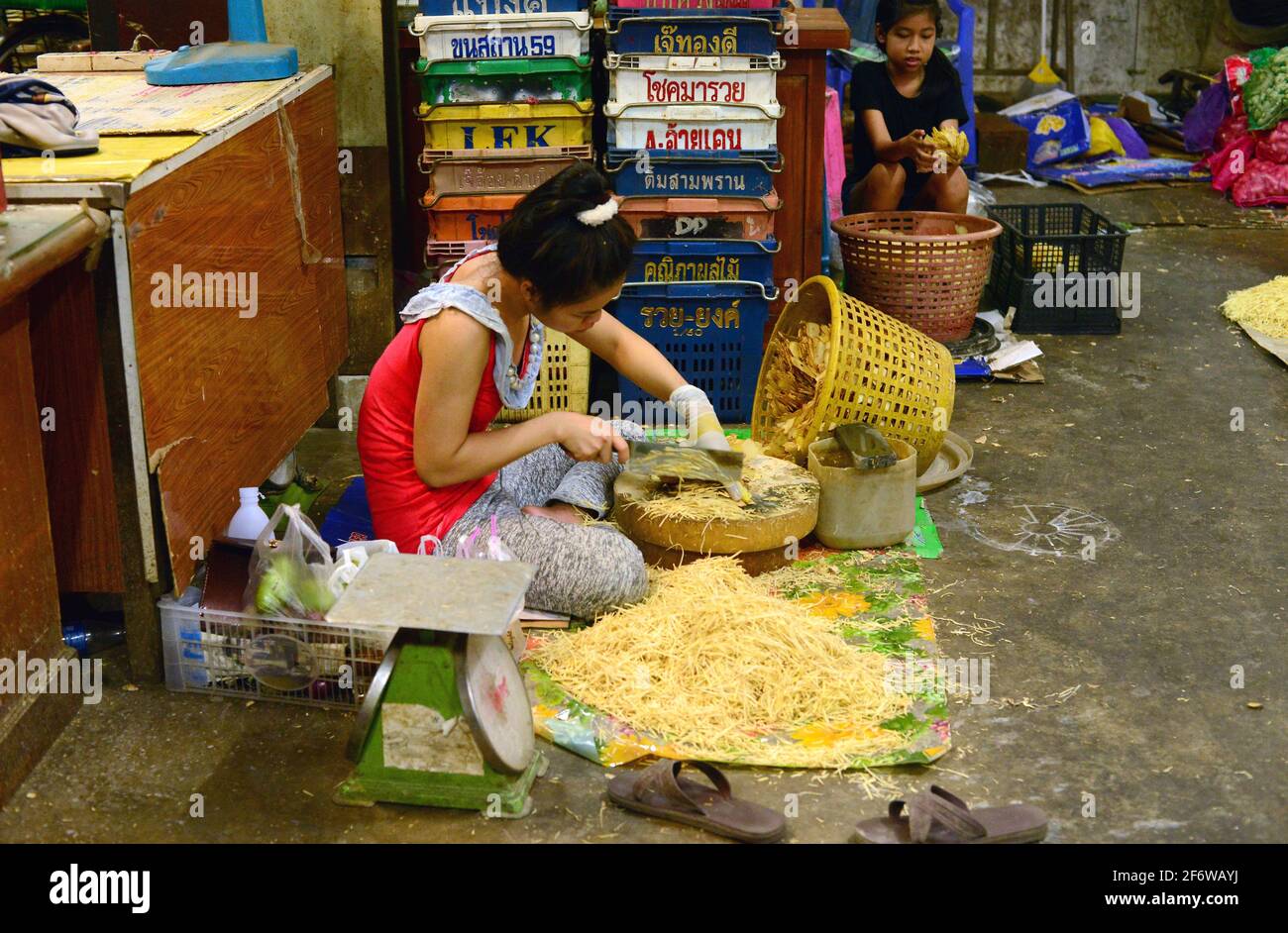 Bangkok, market (woman cutting ginger). Thailand. Stock Photo