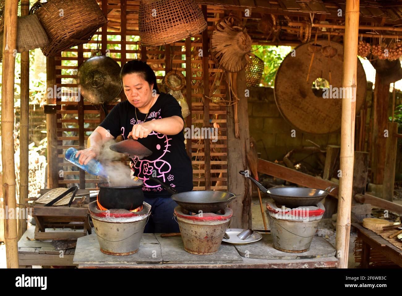 Chiang Mai, woman cooking on a traditional house. Thailand. Stock Photo