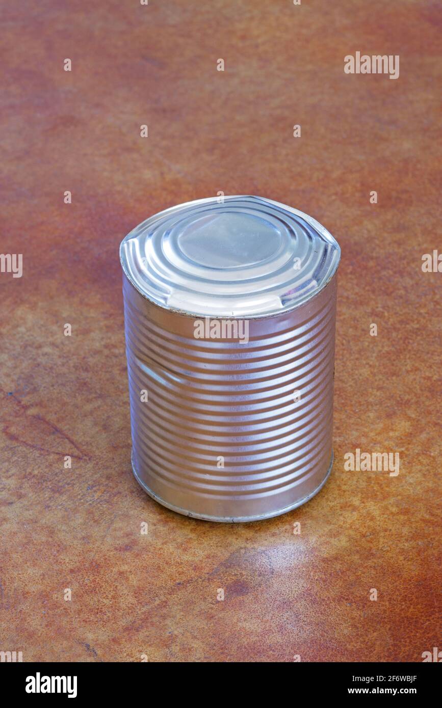 bulging spoiled canned metal food can with no label Stock Photo