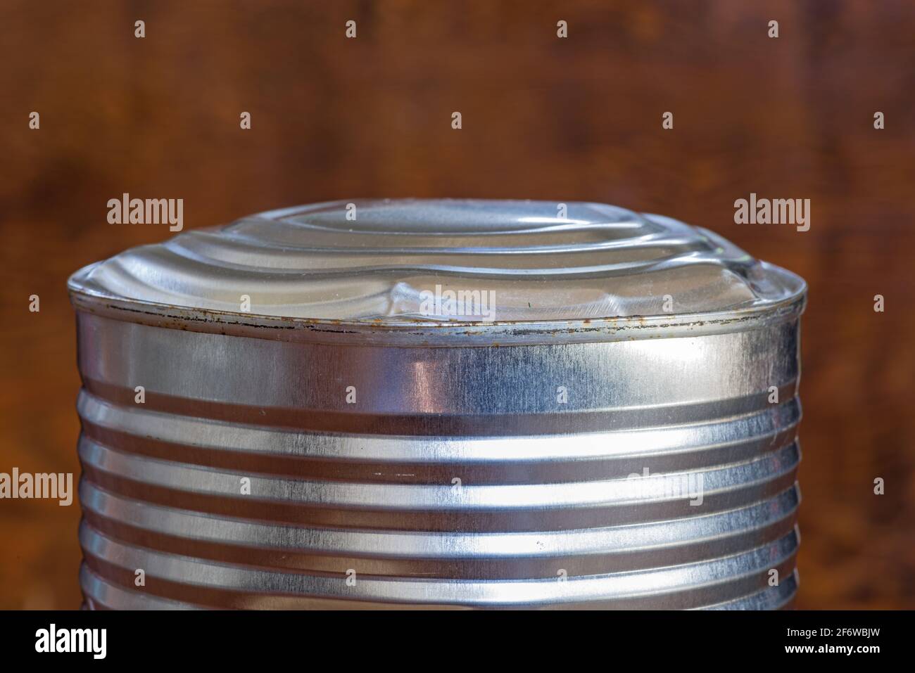bulging old food can end indicating spoiled contents Stock Photo