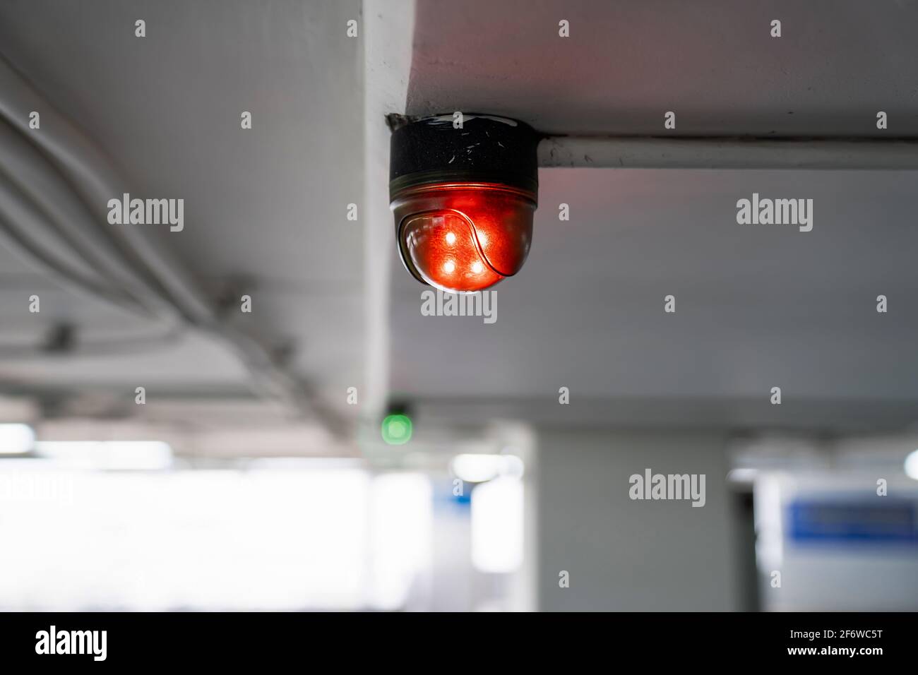 Close up to overhead LED status light of car parking in department