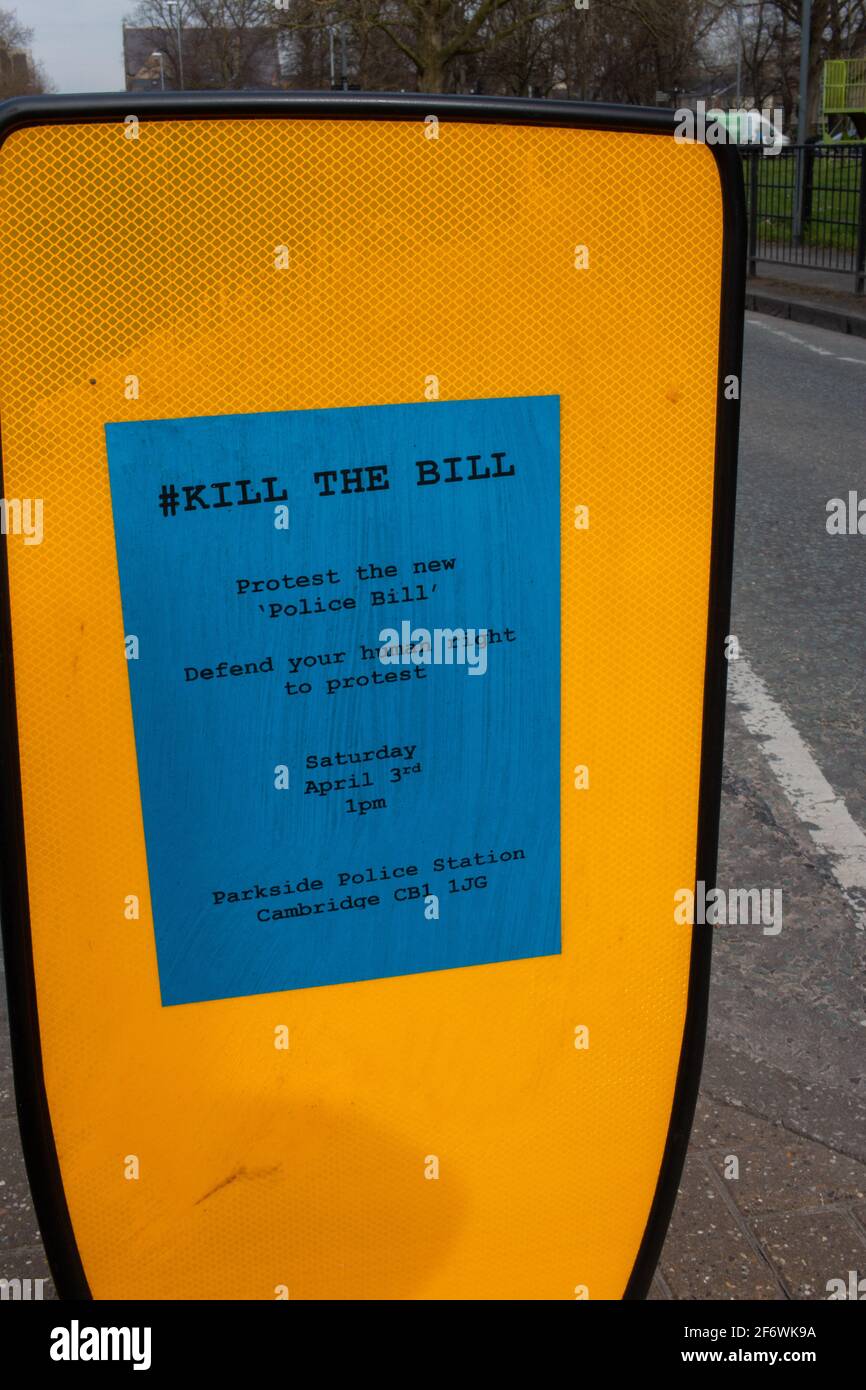 A blue poster on a reflective yellow background showing details of a protest march against new legislation limiting public protests, Cambridge, UK. Stock Photo