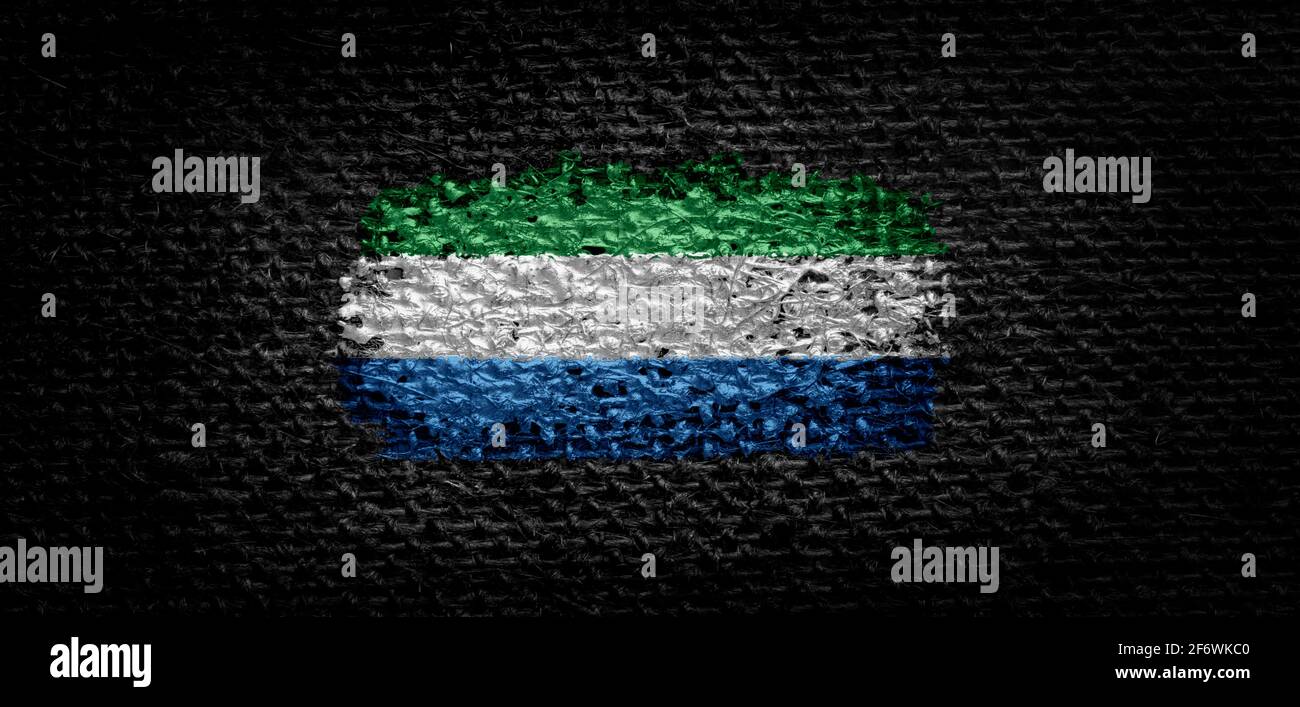 National flag of the Sierra Leone on dark fabric Stock Photo