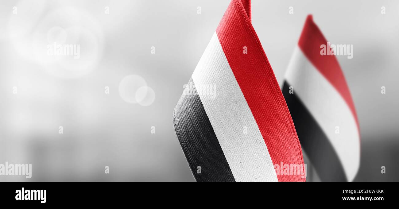 Small national flags of the Yemen on a light blurry background Stock Photo
