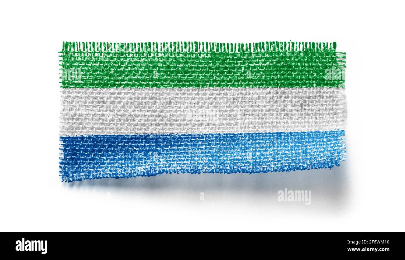 Sierra Leone flag on a piece of cloth on a white background Stock Photo ...