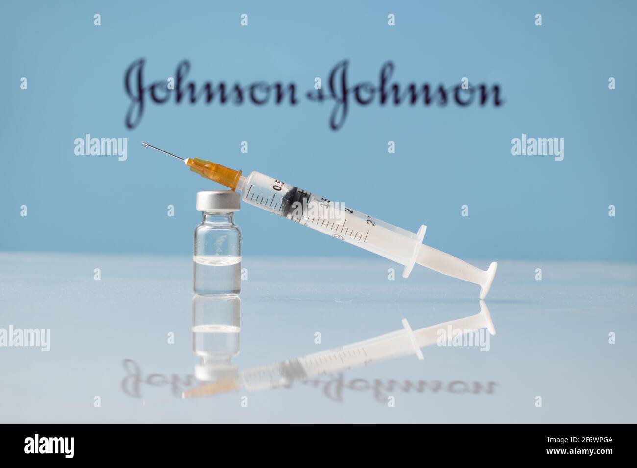 Johnson and Johnson Coronavirus Vaccine vial and syringe with logo as background. LJUBLJANA, SLOVENIA: March 25, 2021 Stock Photo