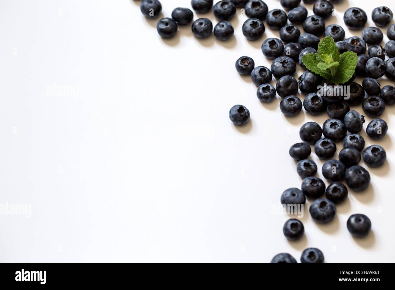 Fresh juicy blueberries background. Flat lay top view copy space. Healthy berry, organic food, antioxidant, vitamin, blue food. Stock Photo