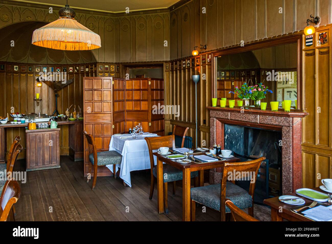 The restaurant in the former dining room with original wood paneling. The small fireplace room can also be booked for an intimate dinner for two! Stock Photo