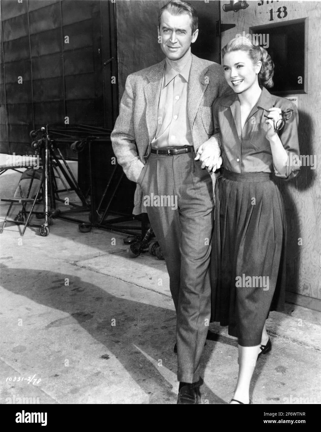 JAMES STEWART and GRACE KELLY on set candid during filming of REAR WINDOW 1954 director ALFRED HITCHCOCK screenplay John Michael Hayes based on a short story by Cornell Woolrich Alfred J. Hitchcock Productions / Paramount Pictures Stock Photo