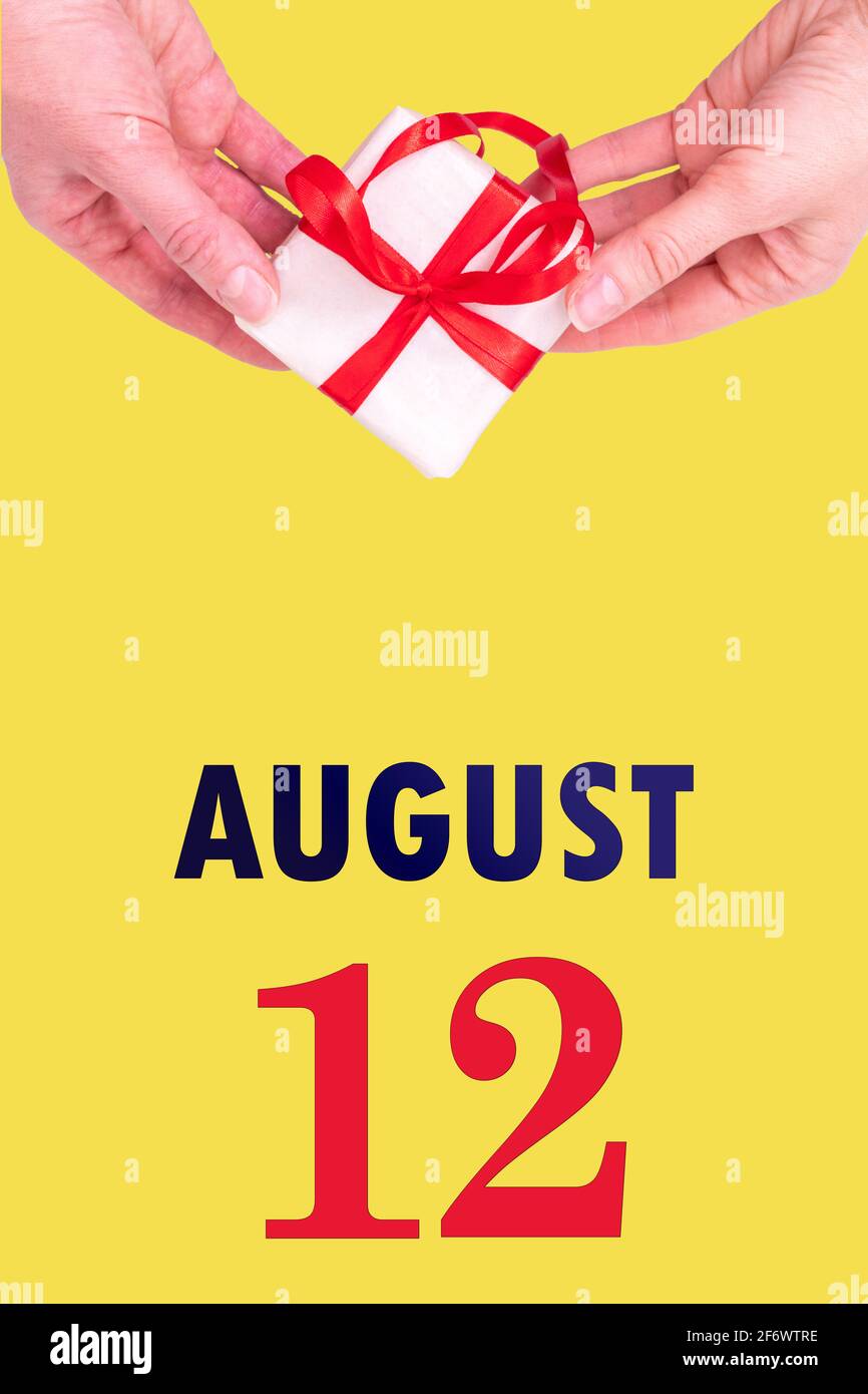 August 12th. Festive Vertical Calendar With Hands Holding White Gift