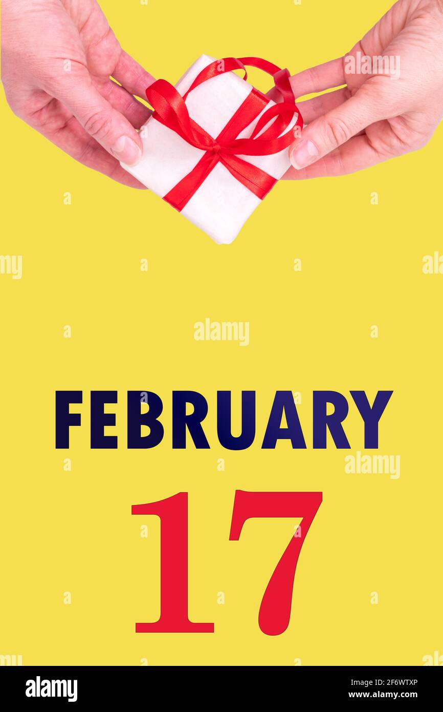 February 17th. Festive Vertical Calendar With Hands Holding White Gift