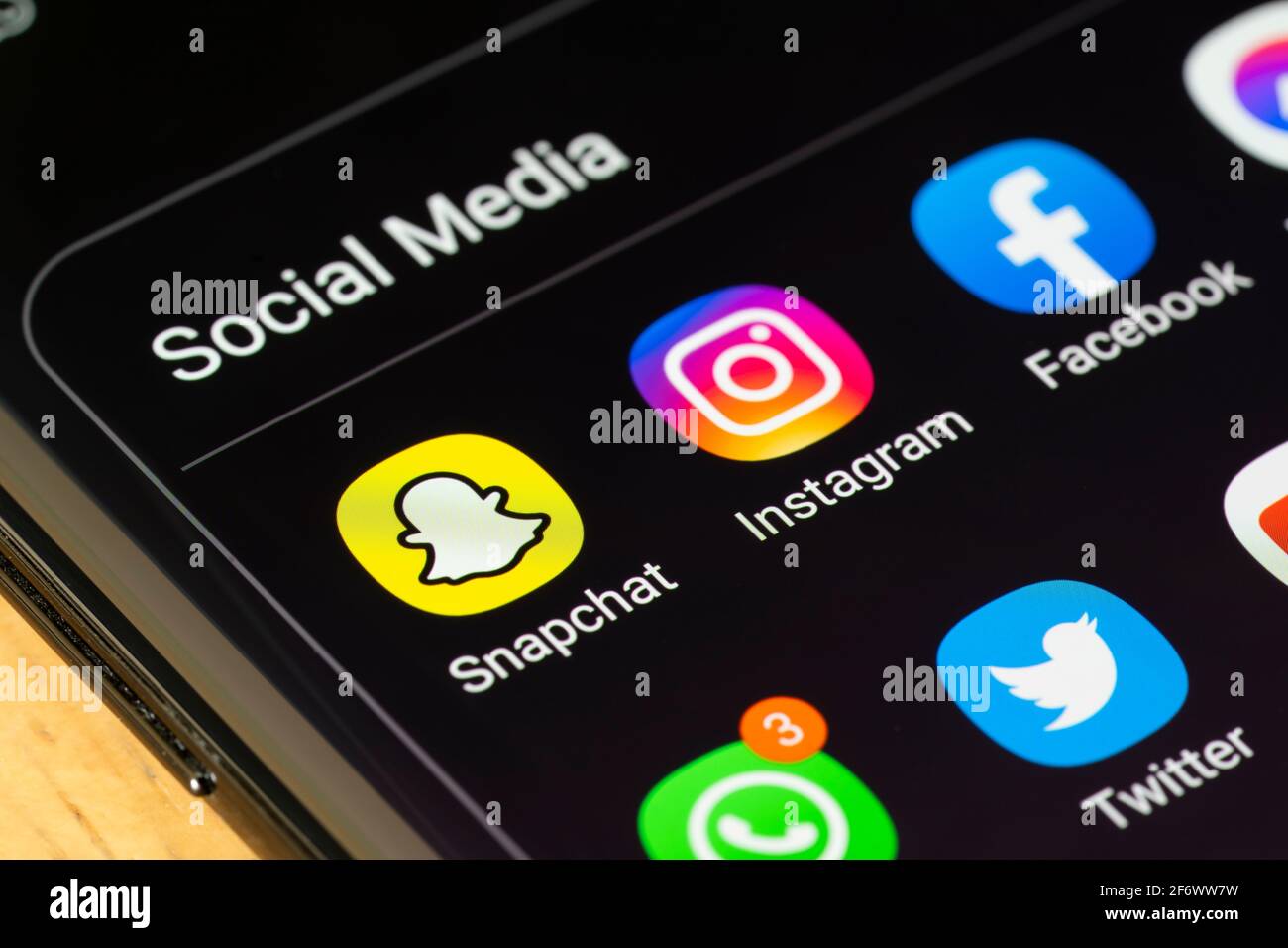 A grouped selection of icons for multimedia Social Media apps in a folder on a smartphone screen, including Snapchat, Instagram, Facebook and Twitter Stock Photo