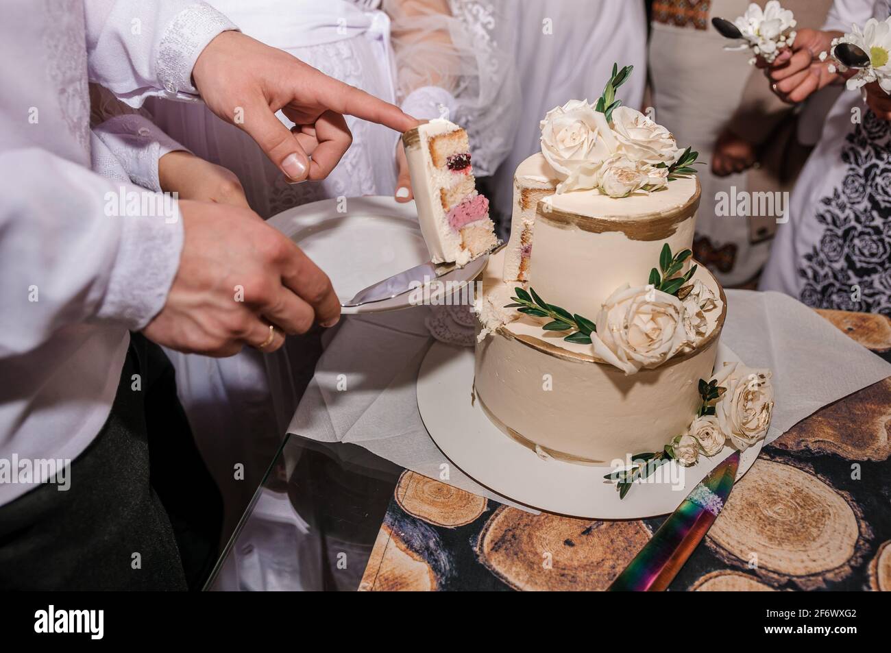 Newlyweds cut the wedding cake. The bride and groom at the wedding cut