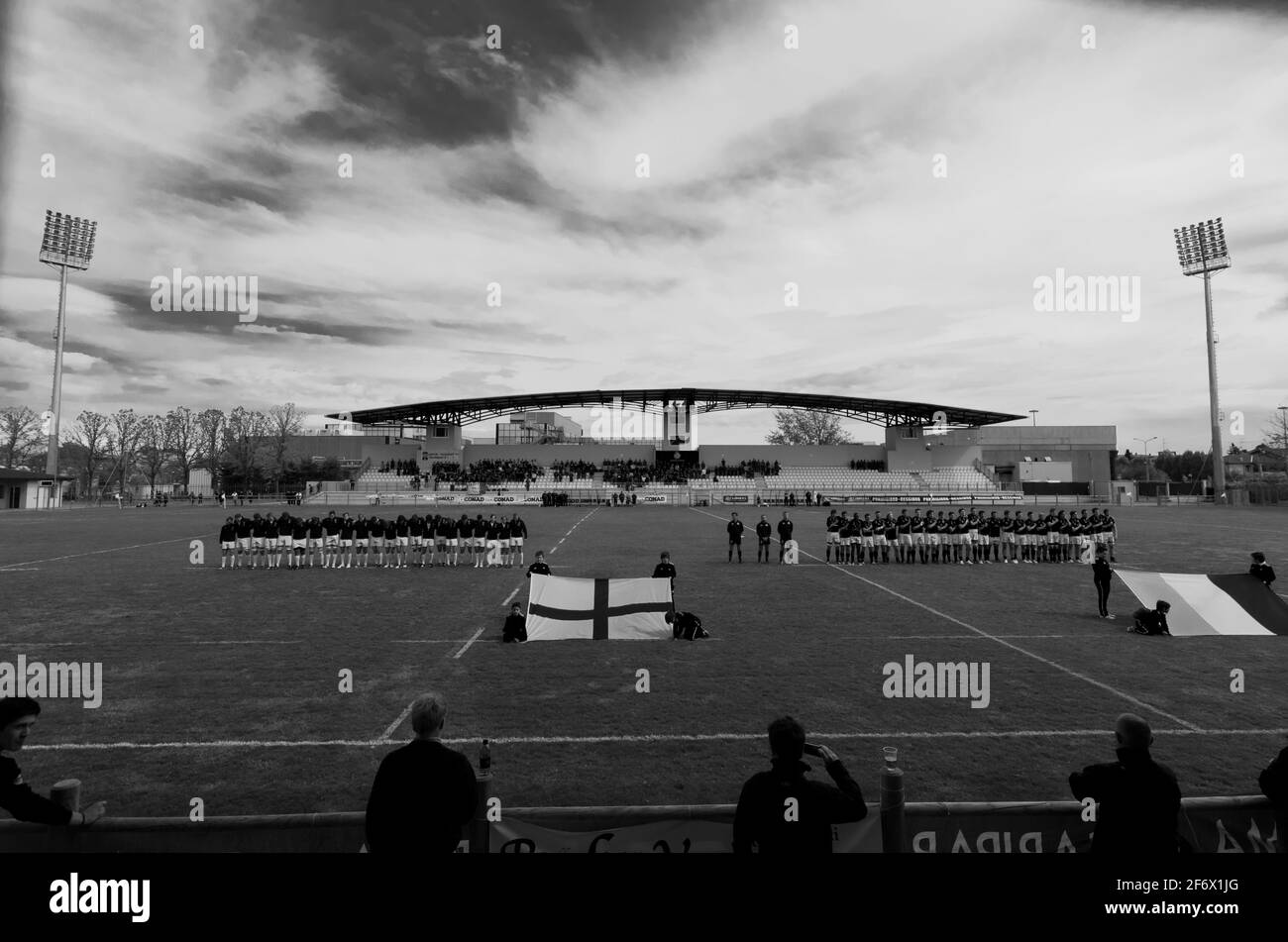 The rugby stadium in Parma, Italy. The teams line up behind their flags prior to a game between England U16s and Italy U17s in 2012..B&W Stock Photo