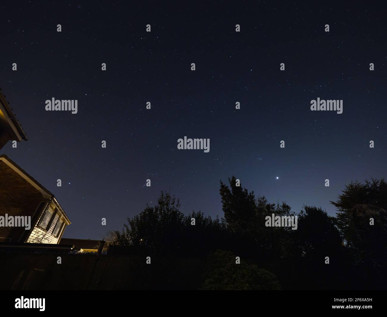 The Moon, the constellation of Orion, Sirius the Dog Star, The Pleiades and the planet Venus in the night sky over Sussex, England. Stock Photo