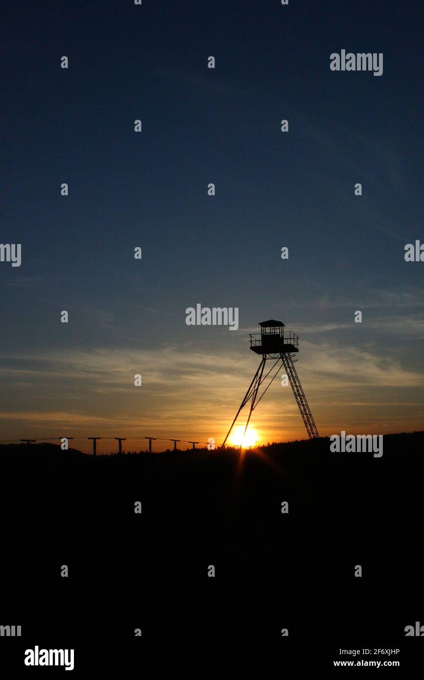 Historical watchtower as a remain of Cold war Iron curtain Stock Photo