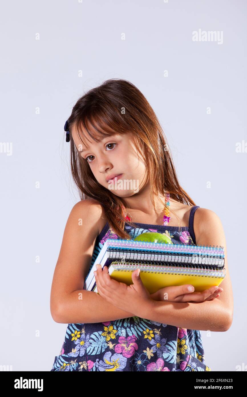 Little girl holding books and a apple ready to go to school Stock Photo ...