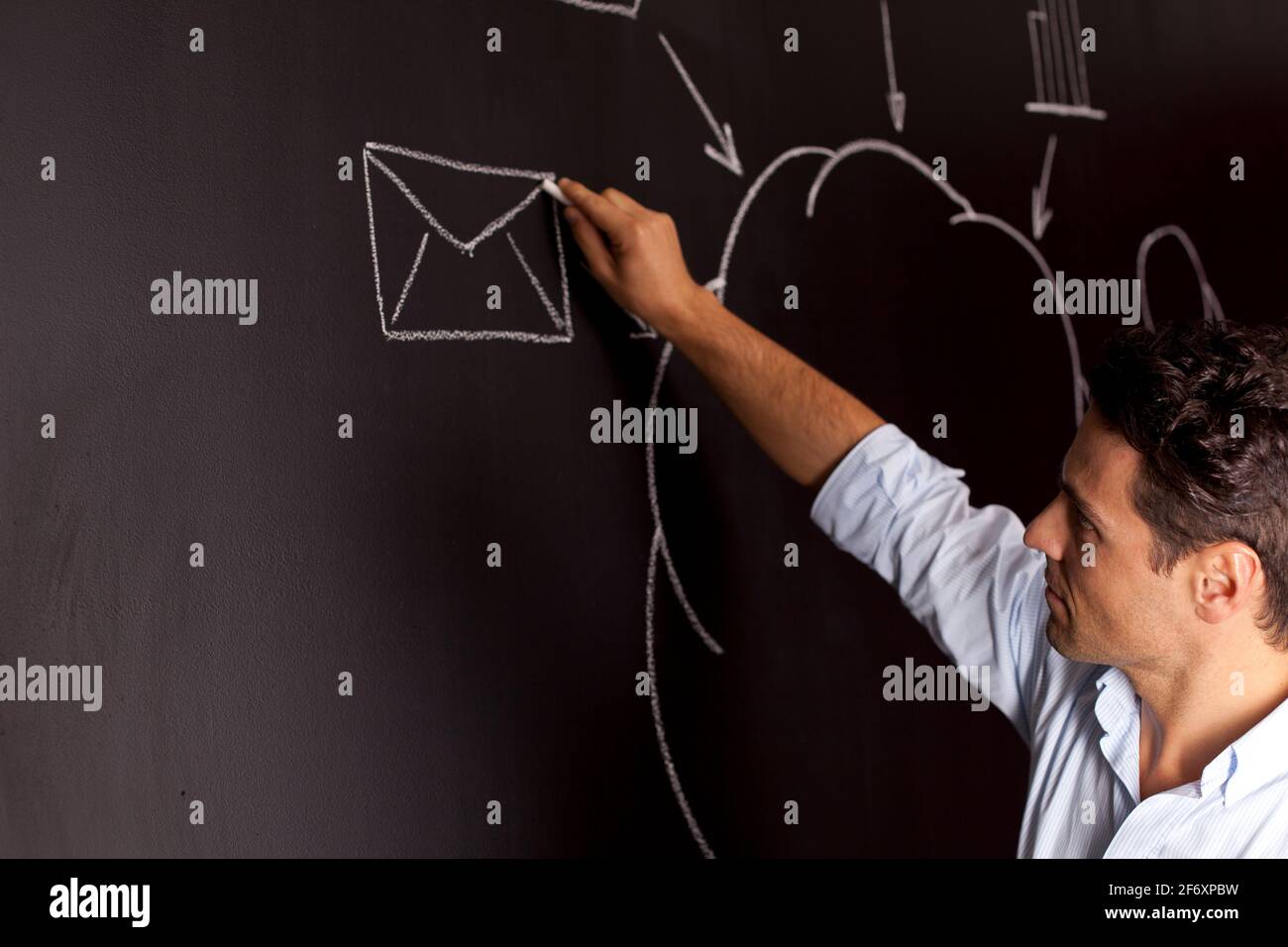 Businessman writing a cloud computing diagram on the chalkboard Stock Photo
