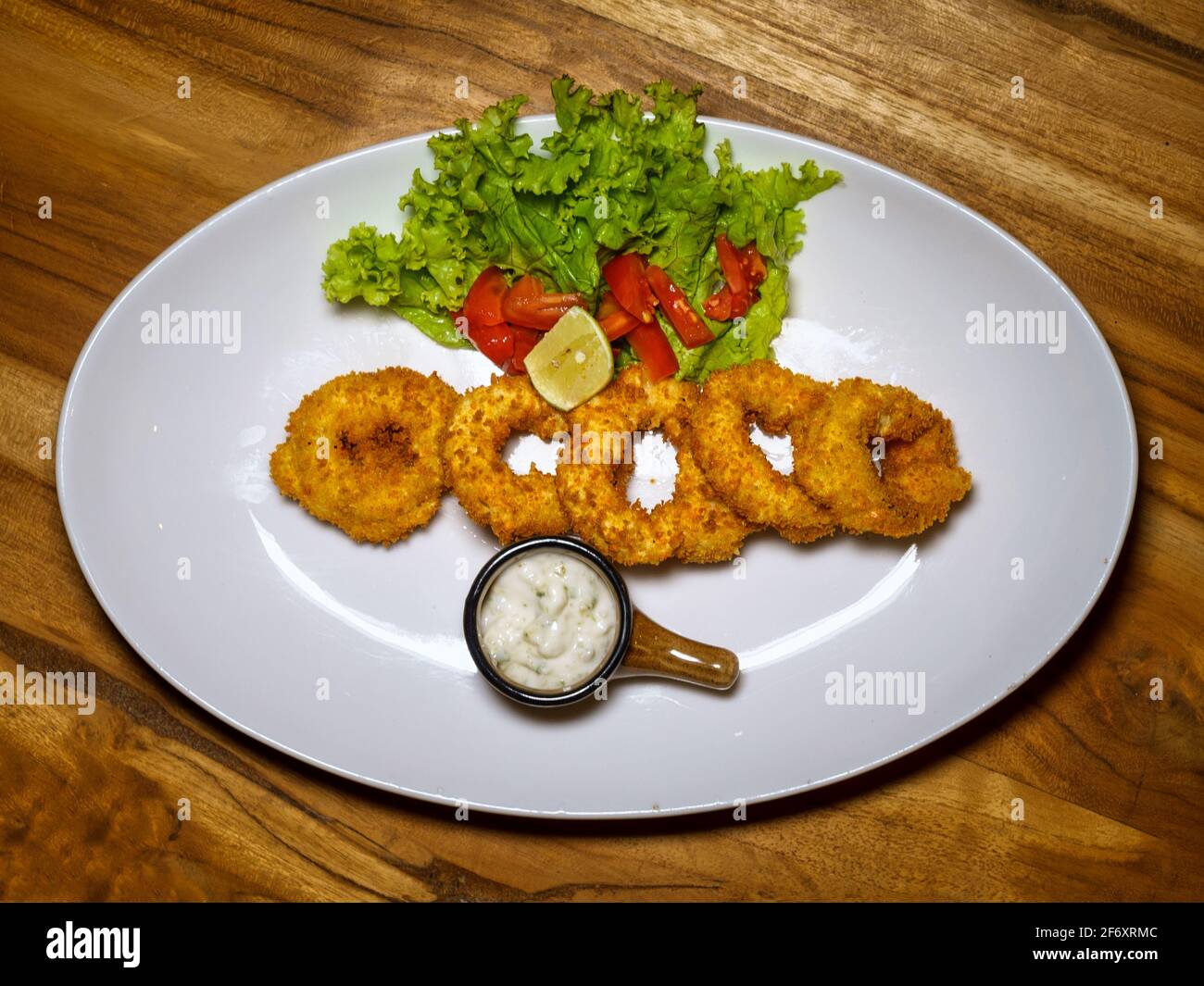 Overhead view of deep fried onion rings with tartar sauce Stock Photo