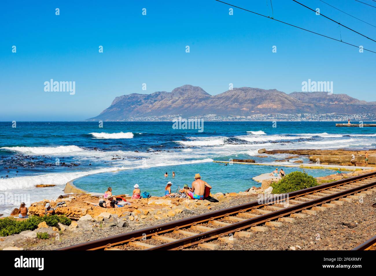 Cape Town, South Africa - March 23, 2021: Passenger rail running through small coastal town of St James Stock Photo