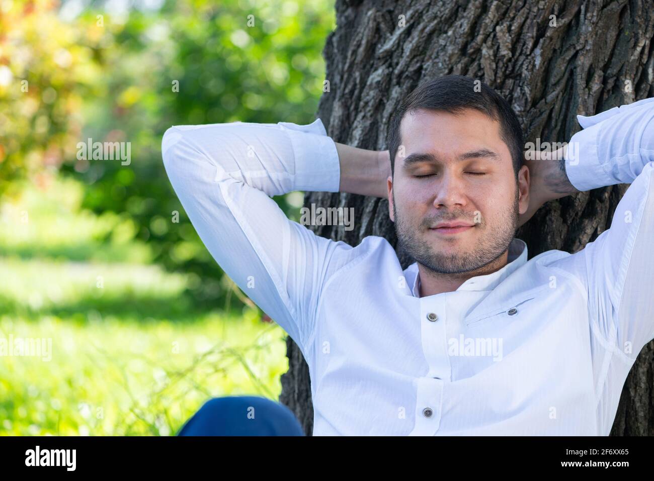 Man sitting under tree face hi-res stock photography and images - Alamy
