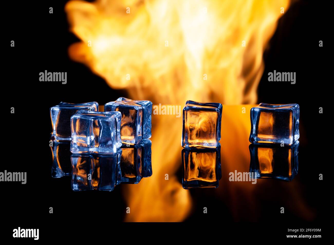 ice cubes on a black background in flames Stock Photo