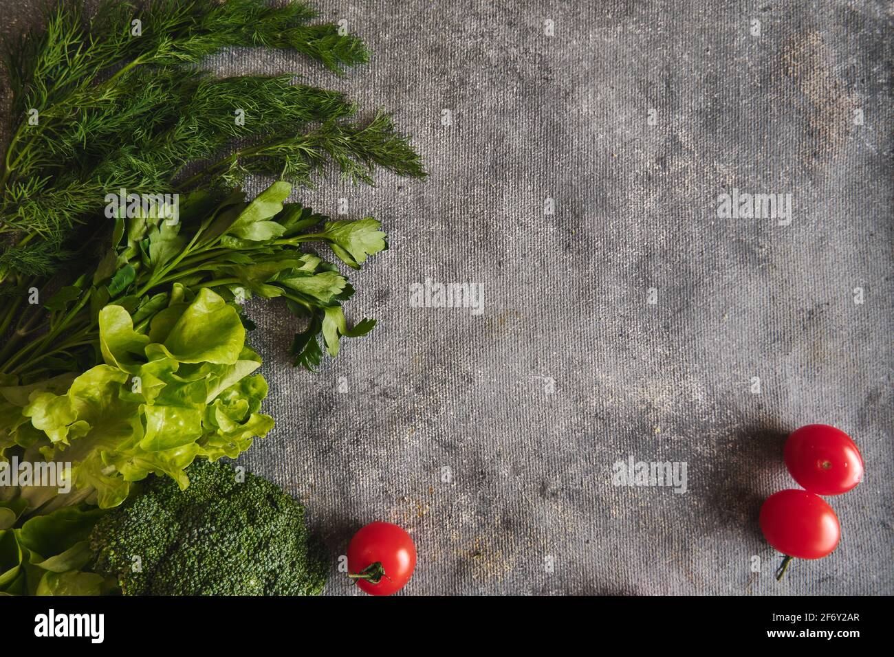Broccoli and tomatoes on gray background Stock Photo